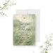 Personalized garden wedding invitation with misty sage watercolor greenery, leafy monogram wreath, couple’s names, venue and event details-front