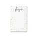 Personalized white notepad with a custom name in black script and elegant gold confetti border on a minimalist stationery design.