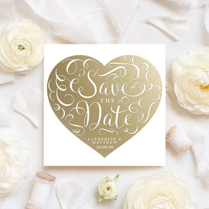 Square wedding save the date card with a large gold heart, ornate white script lettering and personalized names and date-front