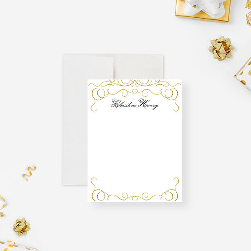 Personalized note card with a white front framed by printed gold ornamental scrollwork and a personalized name. Shown with a white envelope.