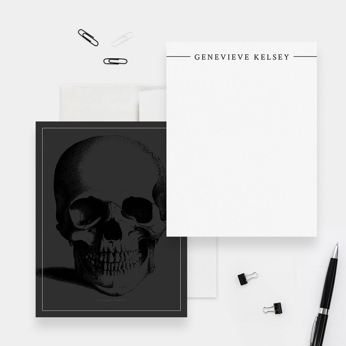 Personalized white note card with a black name header, beside a dark gray back featuring a black skull illustration.