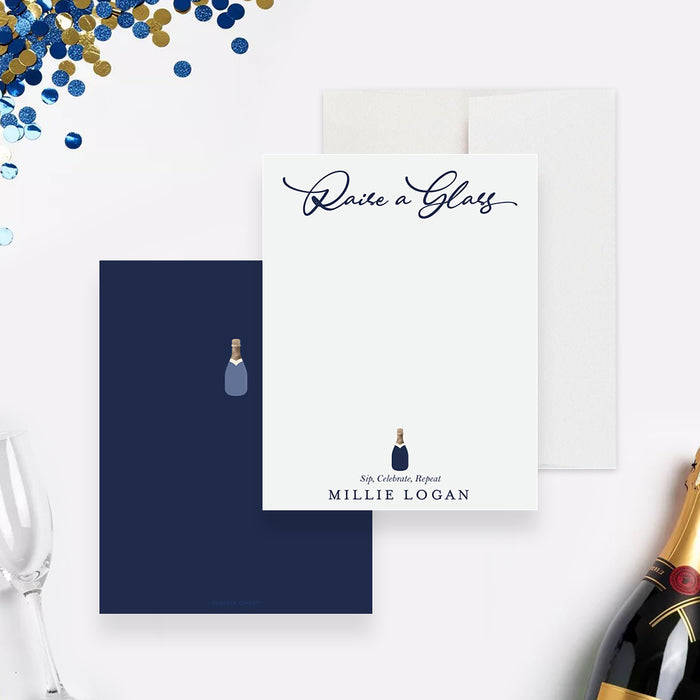 personalized navy graduation thank you card with "Raise a Glass" wording, champagne bottle illustration, and custom name-front-back