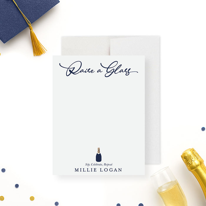 personalized navy graduation thank you card with "Raise a Glass" wording, champagne bottle illustration, and custom name-front
