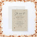 Neutral beige graduation party invitation card with “She Did It” script headline and a sparkle design-front
