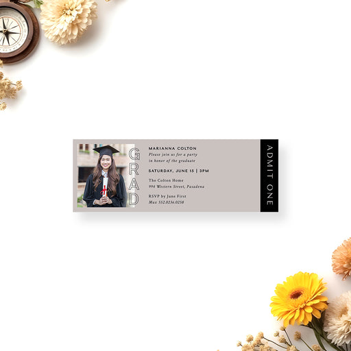 Graduation ticket invitation with photo of graduate in cap and gown and GRAD typography on neutral background