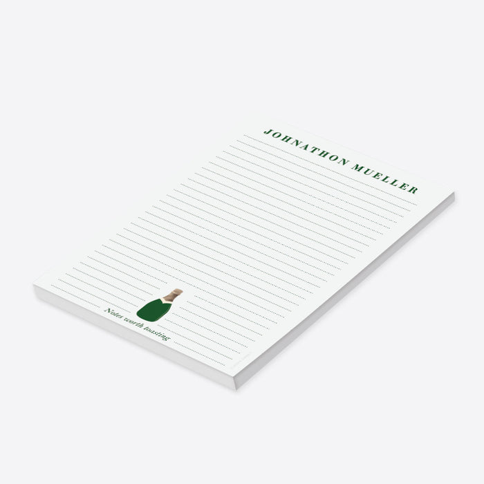 Personalized champagne bottle notepad with green bottle artwork, custom name, and lined pages-side