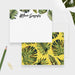 Personalized note cards with green palm leaves around the name and a yellow reverse covered in tropical foliage.