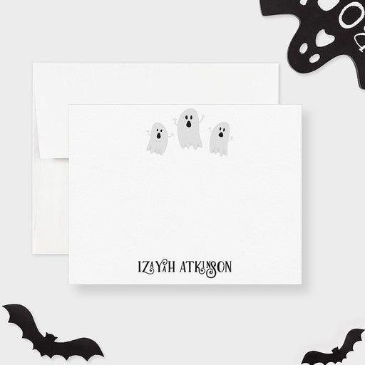Personalized note card with three friendly ghosts and a personalized name, shown with a white envelope.