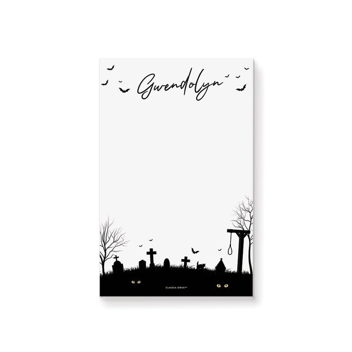 personalized Halloween notepad with spooky graveyard silhouette, bats, tombstones, custom name, and blank writing space