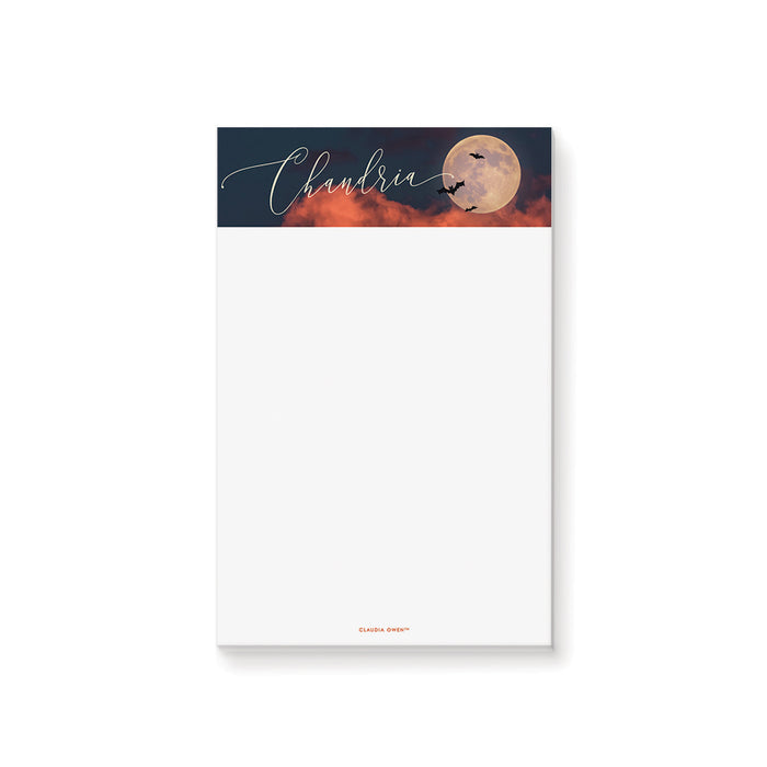 Personalized Halloween notepad with custom name, full moon, bats, dark sky artwork, and blank writing space