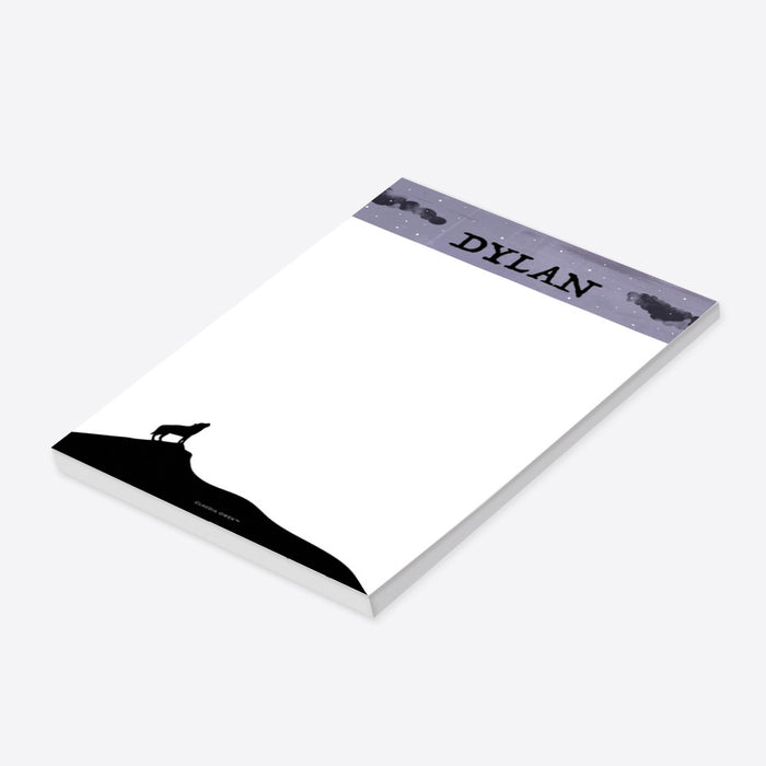 personalized Halloween notepad with howling wolf silhouette, starry purple sky, custom name, and blank writing space-side