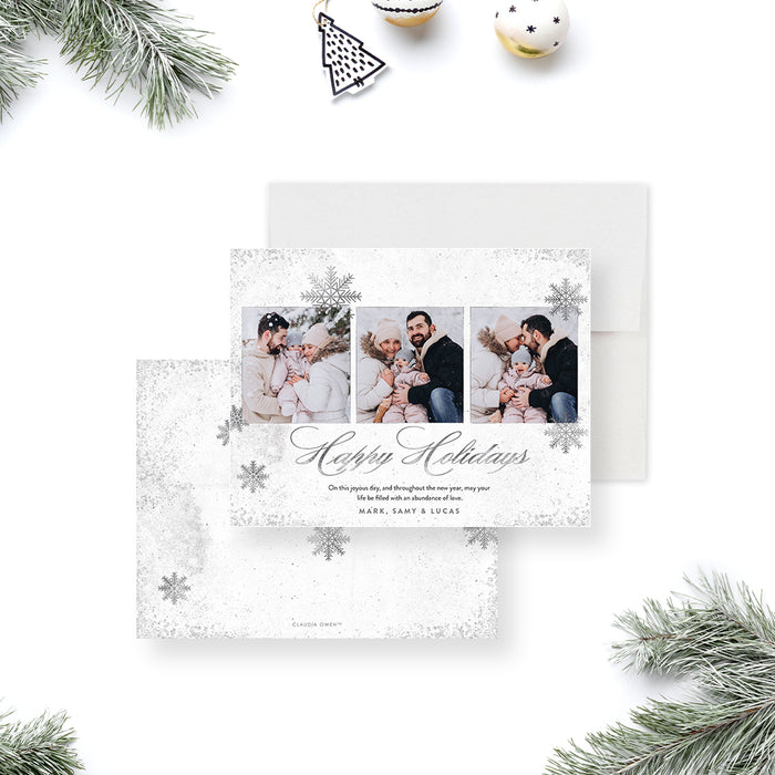 Personalized holiday greeting card featuring a winter snowflake design and multiple family photos-front-back