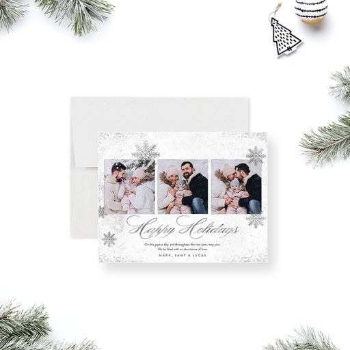 Personalized holiday greeting card featuring a winter snowflake design and multiple family photos-front