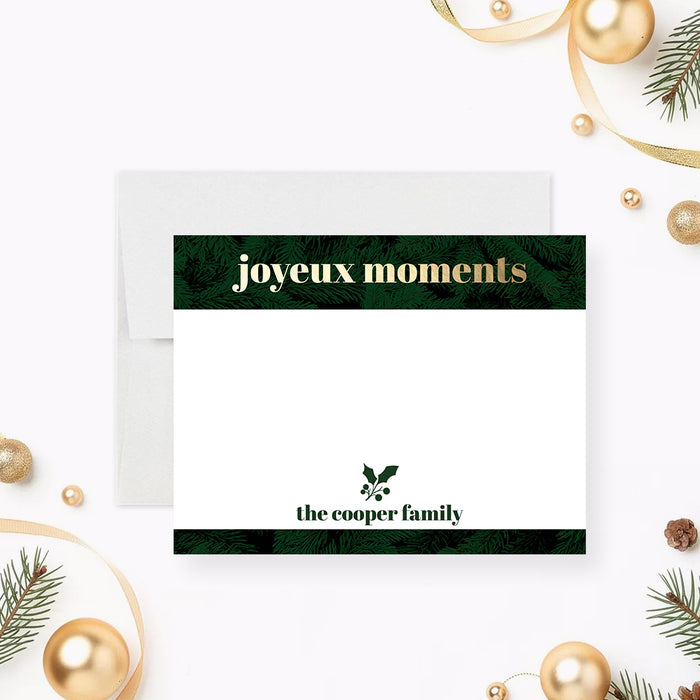 Personalized holiday note card with evergreen foliage borders, gold "joyeux moments" lettering, holly illustration, custom family name and a spacious writing area-front