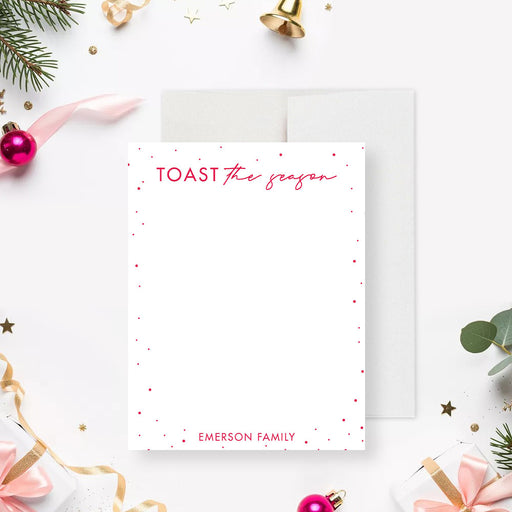 personalized holiday note card with Toast the Season wording, red dotted border, custom family name, and blank writing space-front