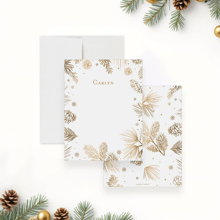 personalized holiday note card with gold-toned pine branches, pinecones, snowflakes, festive border, and custom name-front-back