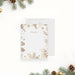 personalized holiday note card with gold-toned pine branches, pinecones, snowflakes, festive border, and custom name-front