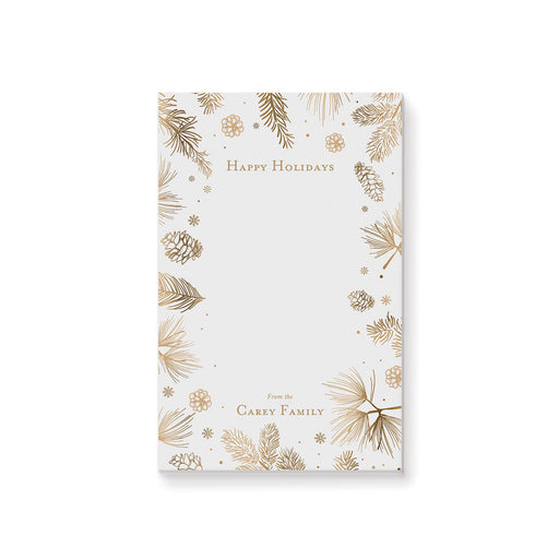 personalized holiday notepad with gold-toned pine branches, pinecones, snowflakes, festive border, and custom family name