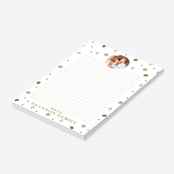 personalized holiday photo notepad with custom family photo, gold-colored snowflakes, acorns, dots, and lined writing space-side