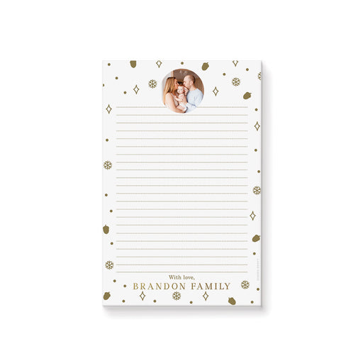 personalized holiday photo notepad with custom family photo, gold-colored snowflakes, acorns, dots, and lined writing space