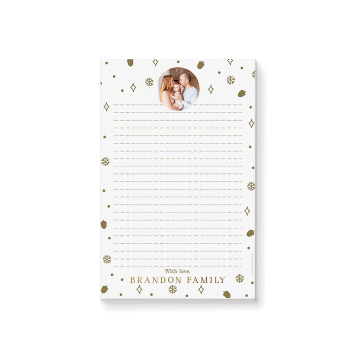 personalized holiday photo notepad with custom family photo, gold-colored snowflakes, acorns, dots, and lined writing space