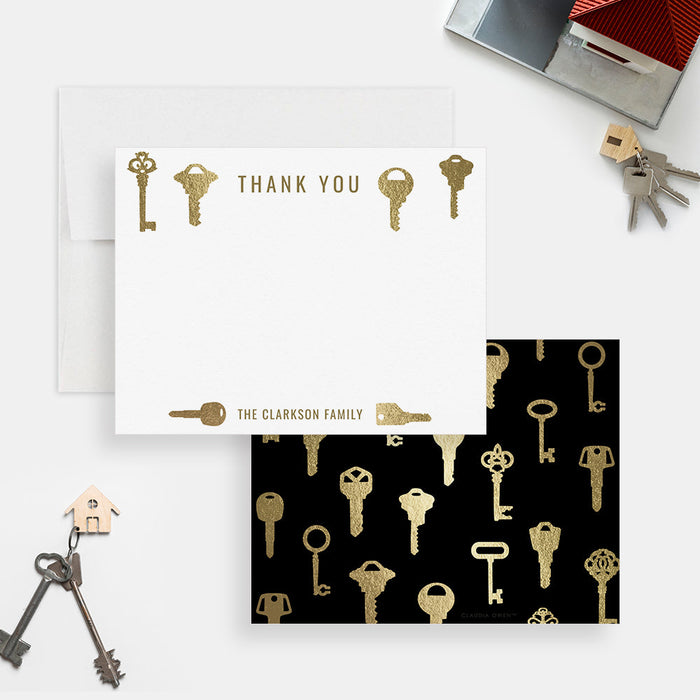 Front and back of personalized note cards with a decorative printed gold key design and personalized family name and a black back patterned with printed gold keys.