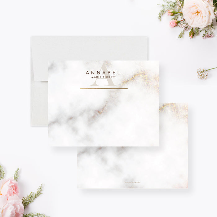 Personalized white and gray marble note cards with a name, monogram and printed gold lines on the front and a marble pattern on the reverse.