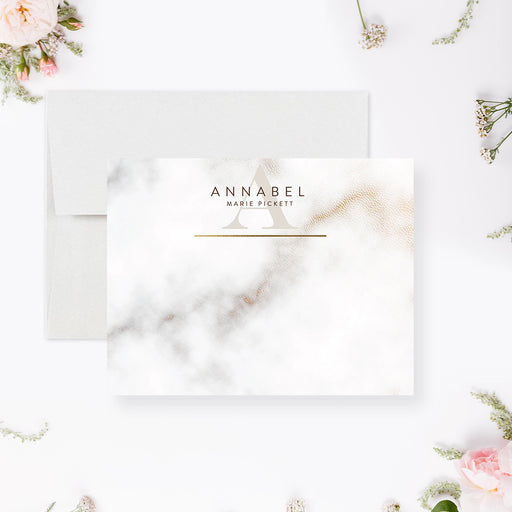 Personalized white and gray marble note cards with a name, monogram and printed gold lines on the front and a marble pattern on the reverse.