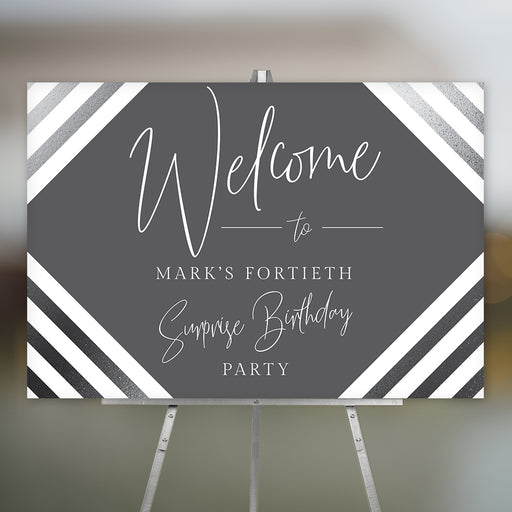 Personalized gray 40th birthday party welcome sign for men with honoree’s name, black-and-white diagonal stripes and modern script lettering