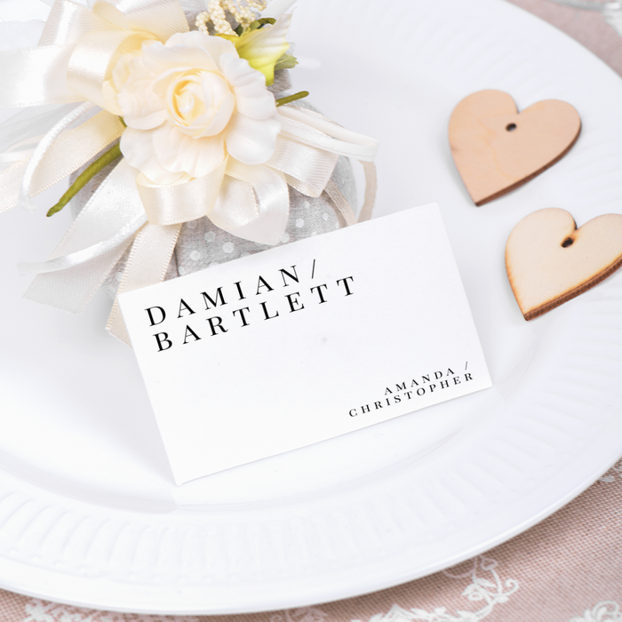 Place card with name on a decorative setting with flowers and dinner plate
