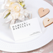 Place card with name on a decorative setting with flowers and dinner plate