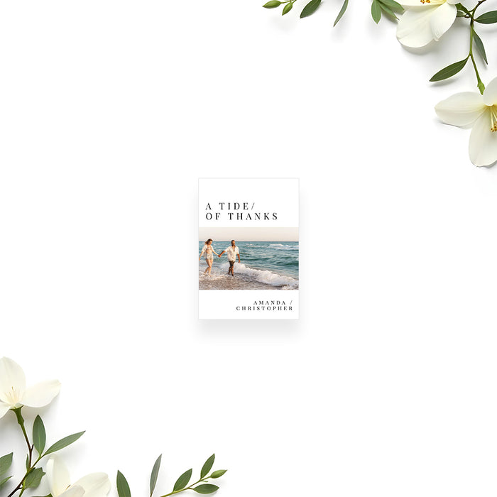 Favor tag card with photo of couple on beach and text 'A Tide of Thanks' on a white background with floral elements.