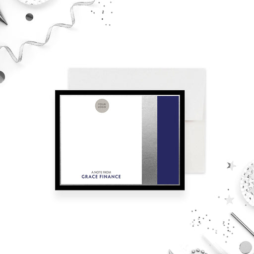 Personalized note card with a white front with a black frame, navy side panel, printed silver accents, and business wording. Shown with a white envelope.