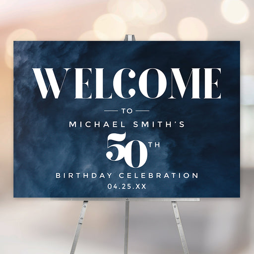 Personalized 50th birthday welcome sign with dark navy blue watercolor background, white modern lettering, honoree’s name, and celebration date