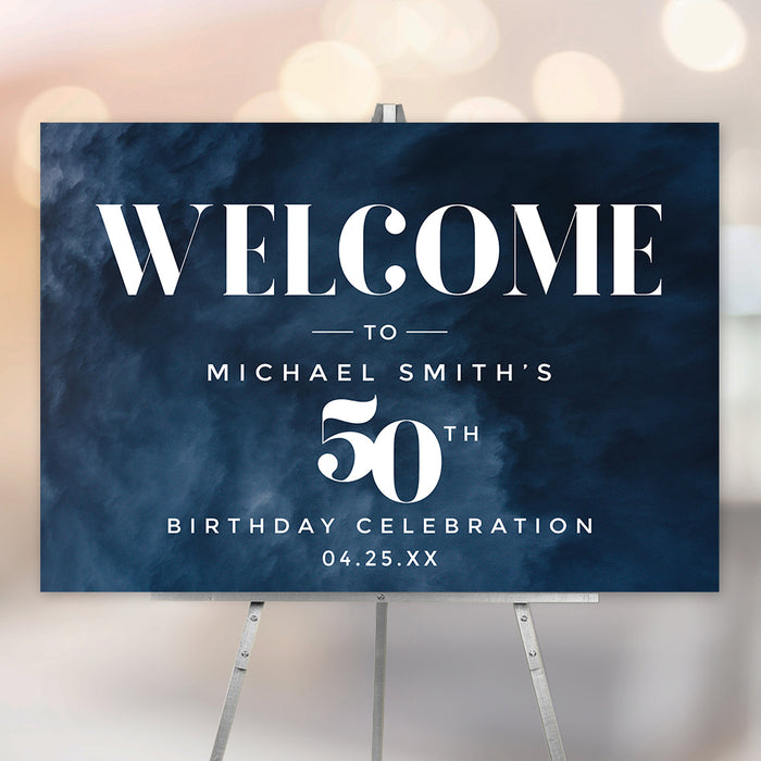 Personalized 50th birthday welcome sign with dark navy blue watercolor background, white modern lettering, honoree’s name, and celebration date