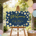 Personalized baby shower welcome sign featuring white daisies, yellow accents and elegant script lettering on a navy blue background