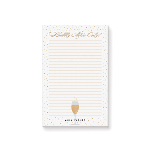 Champagne celebration notepad with confetti dot design and bubbly notes lettering for party planning and personalized stationery.