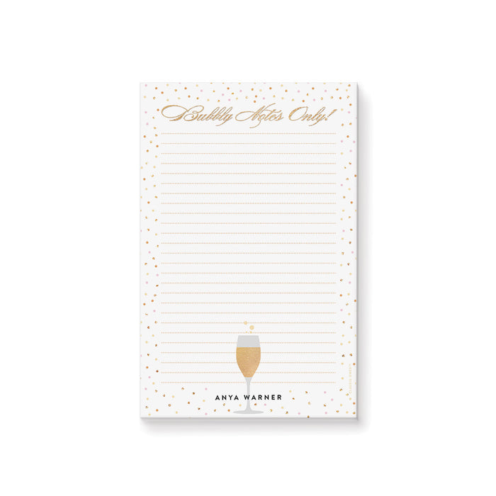 Champagne celebration notepad with confetti dot design and bubbly notes lettering for party planning and personalized stationery.
