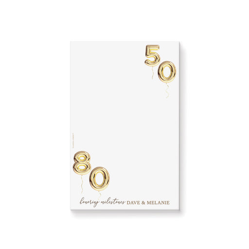 Personalized joint milestone birthday notepad with gold balloon numbers for two celebrants celebrating a shared birthday party.