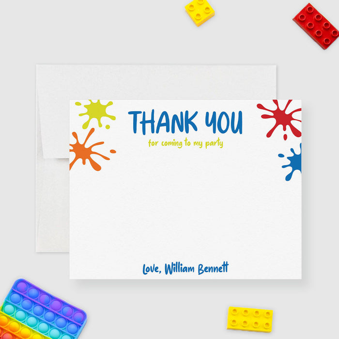 Personalized note card with colorful paint splashes, thank you wording and a personalized name, shown with a white envelope.