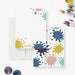 Front and back of personalized note cards with colorful paint splatters around a white writing area and a colorful paint splatter patterned back.