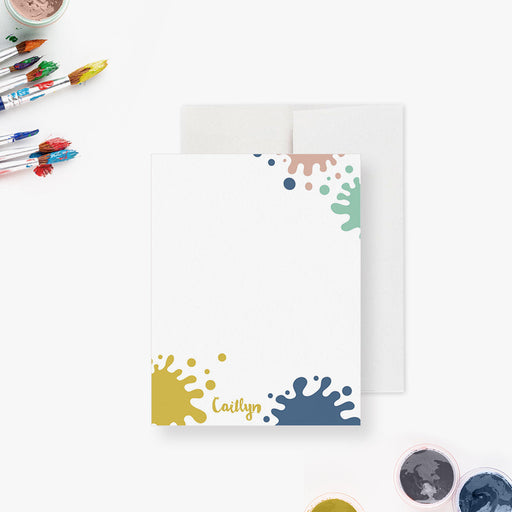Personalized note card with colorful paint splatters around a white writing area, shown with a white envelope.