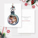 Watercolor Christmas ornament photo card featuring a round bauble frame with a family portrait inside, decorated with holly and a twine bow