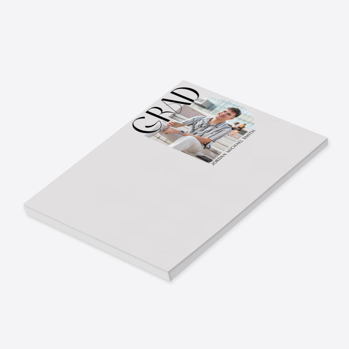 Personalized graduation photo notepad with bold GRAD typography and a custom name-side