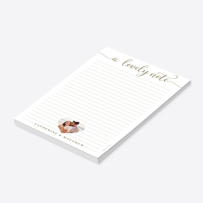 Personalized lined notepad featuring A Lovely Note lettering, a couple photo in a heart-shaped frame and names along the bottom-side