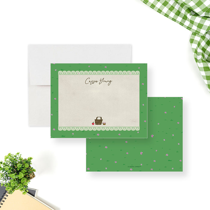 personalized picnic thank you card with custom name, lace border, green grass pattern, tiny pink flowers, and picnic basket illustration-front-back