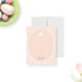 Personalized note card with a pink patterned front with an oval writing area, a floral bunny illustration, and a name. Shown with a white envelope.
