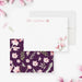 White personalized note card with pink magnolia blossoms, beside a dark purple back patterned with magnolia flowers.