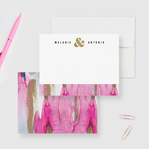 Personalized couple note cards with names and a printed gold ampersand on white and a pink watercolor reverse.