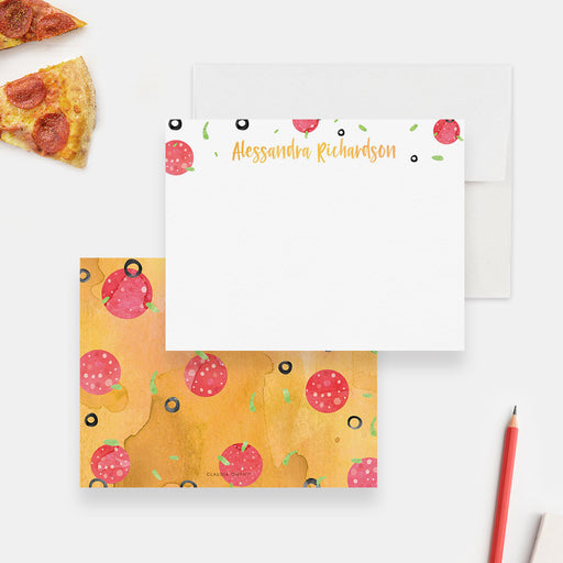 White personalized note card decorated with pizza toppings, beside a yellow back with pepperoni, mushrooms, olives and herbs.